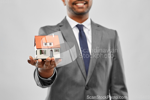 Image of close up of indian man realtor with house model