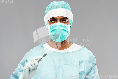 Image of indian male doctor or surgeon with scalpel