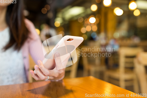 Image of Woman sending sms on mobile phone