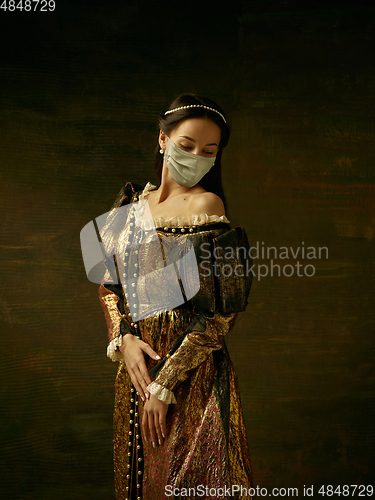 Image of Medieval young woman as a duchess wearing protective mask against coronavirus spread