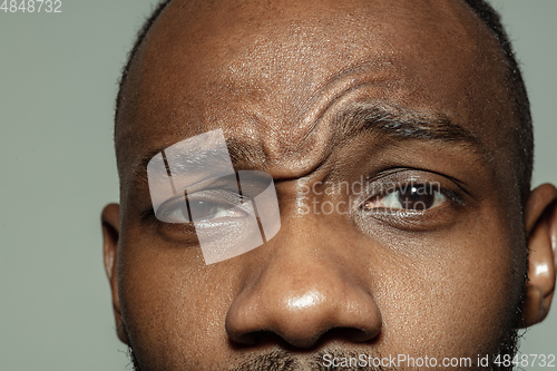 Image of Close up of face of beautiful african-american young man, focus on eyes