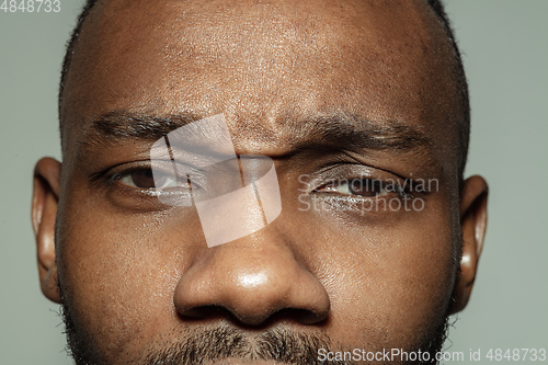 Image of Close up of face of beautiful african-american young man, focus on eyes