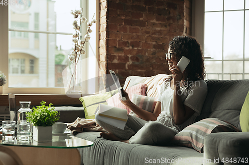 Image of African-american woman, freelancer during the work in home office while quarantine