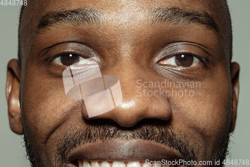 Image of Close up of face of beautiful african-american young man, focus on eyes