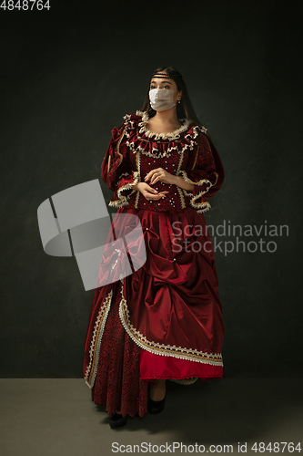 Image of Medieval young woman as a duchess wearing protective mask against coronavirus spread