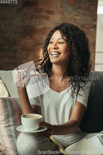 Image of African-american woman, freelancer during the work in home office while quarantine