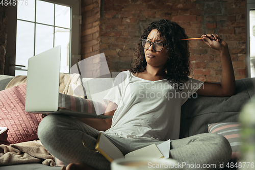 Image of African-american woman, freelancer during the work in home office while quarantine