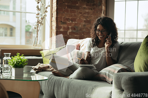 Image of African-american woman, freelancer during the work in home office while quarantine