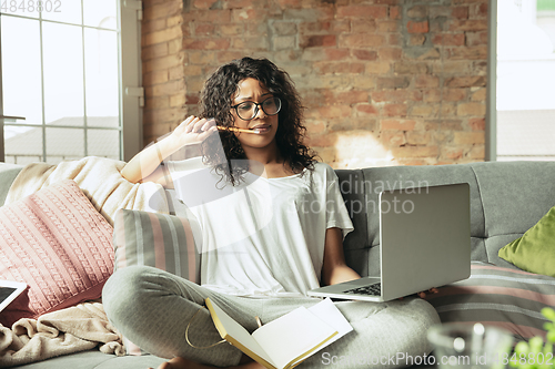 Image of African-american woman, freelancer during the work in home office while quarantine