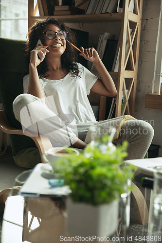 Image of African-american woman, freelancer during the work in home office while quarantine