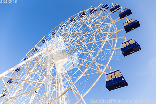 Image of Ferris wheel and sunny blue