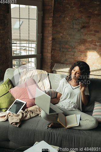 Image of African-american woman, freelancer during the work in home office while quarantine