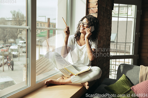 Image of African-american woman, freelancer during the work in home office while quarantine