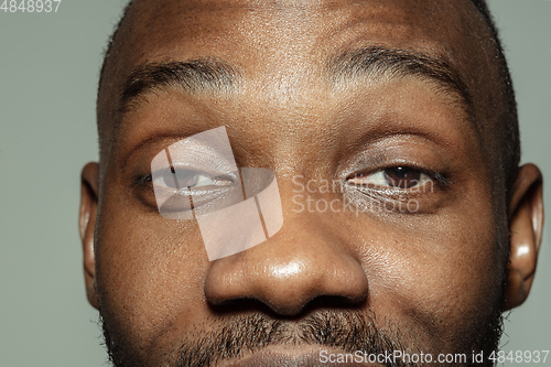 Image of Close up of face of beautiful african-american young man, focus on eyes