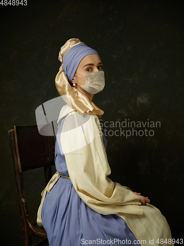 Image of Medieval young woman as a lady with a pearl earring wearing protective face mask against coronavirus spread