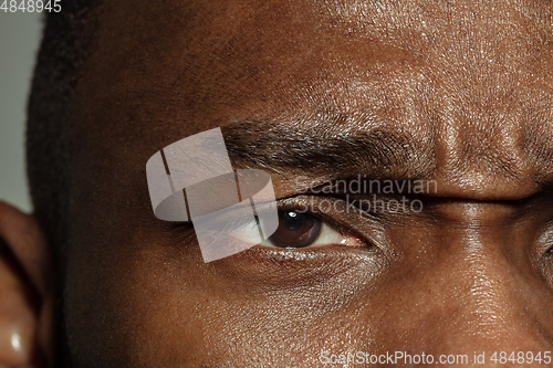 Image of Close up of face of beautiful african-american young man, focus on eyes