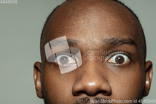 Image of Close up of face of beautiful african-american young man, focus on eyes