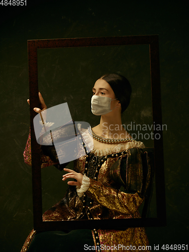 Image of Medieval young woman as a duchess wearing protective mask against coronavirus spread