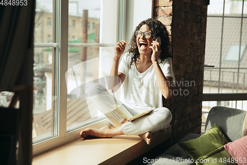 Image of African-american woman, freelancer during the work in home office while quarantine