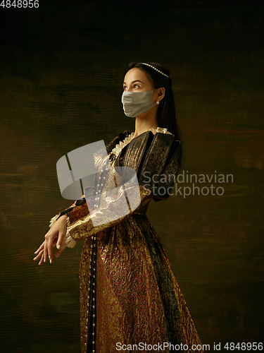 Image of Medieval young woman as a duchess wearing protective mask against coronavirus spread