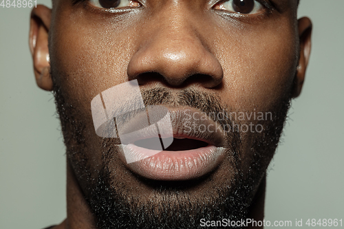 Image of Close up of face of beautiful african-american young man, focus on mouth