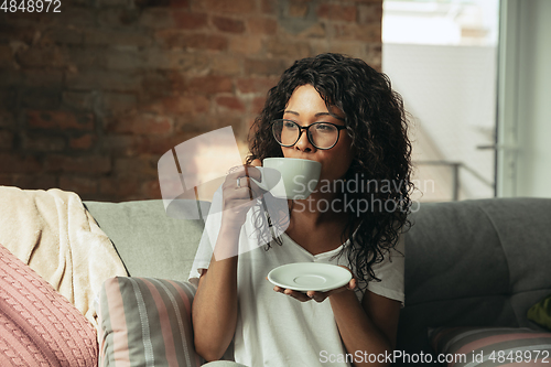 Image of African-american woman, freelancer during the work in home office while quarantine