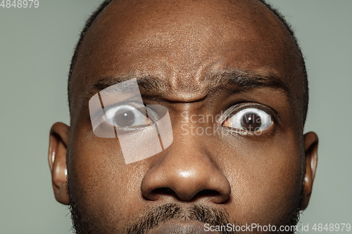 Image of Close up of face of beautiful african-american young man, focus on eyes