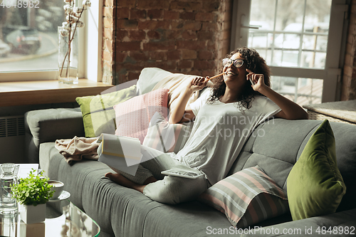 Image of African-american woman, freelancer during the work in home office while quarantine