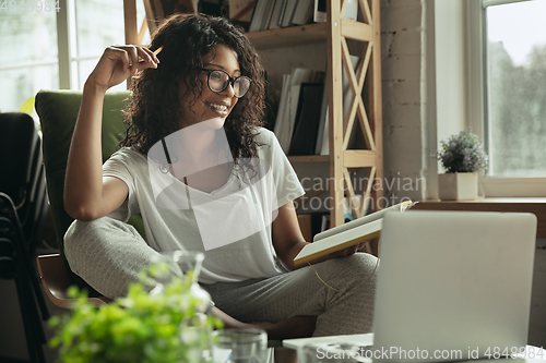 Image of African-american woman, freelancer during the work in home office while quarantine