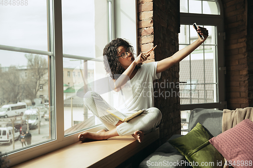 Image of African-american woman, freelancer during the work in home office while quarantine