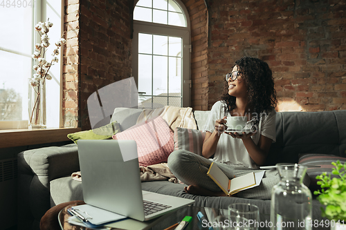 Image of African-american woman, freelancer during the work in home office while quarantine