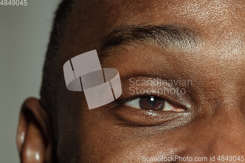 Image of Close up of face of beautiful african-american young man, focus on eyes