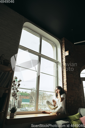 Image of African-american woman, freelancer during the work in home office while quarantine