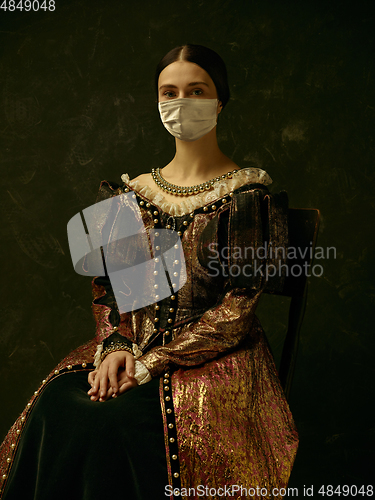 Image of Medieval young woman as a duchess wearing protective mask against coronavirus spread