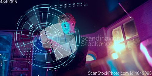 Image of Man using interface modern technology and digital layer effect, VR-headset as business, finance, economics strategy concept