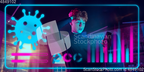 Image of Man using interface modern technology and digital layer effect as information of coronavirus pandemic spread