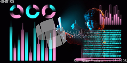 Image of Boy using interface modern technology and digital layer effect as business, finance, economics strategy concept