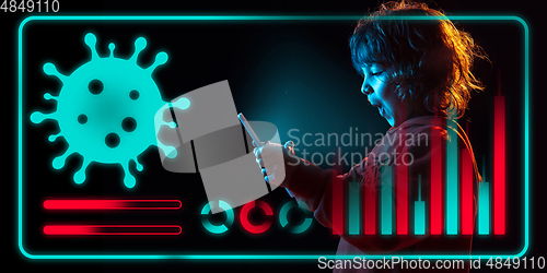 Image of Boy using interface modern technology and digital layer effect as information of coronavirus pandemic spread