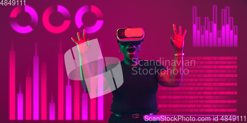 Image of Woman using interface modern technology and digital layer effect, VR-headset as business, finance, economics strategy concept