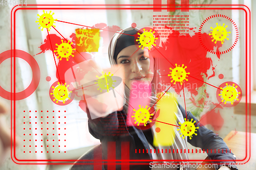 Image of Woman using interface modern technology and digital layer effect as information of coronavirus pandemic spread