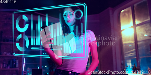 Image of Woman using interface modern technology and digital layer effect as business, finance, economics strategy concept