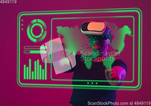 Image of Woman using interface modern technology and digital layer effect, VR-headset as business, finance, economics strategy concept