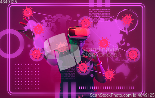 Image of Woman using interface modern technology and digital layer effect as information of coronavirus pandemic spread