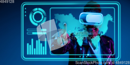 Image of Woman using interface modern technology and digital layer effect, VR-headset as business, finance, economics strategy concept