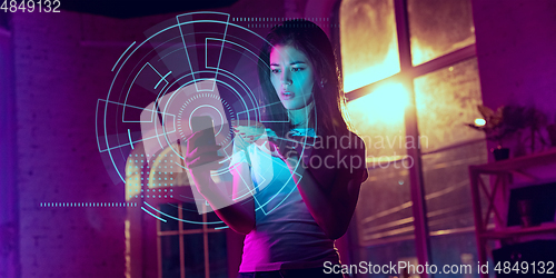 Image of Woman using interface modern technology and digital layer effect as business, finance, economics strategy concept