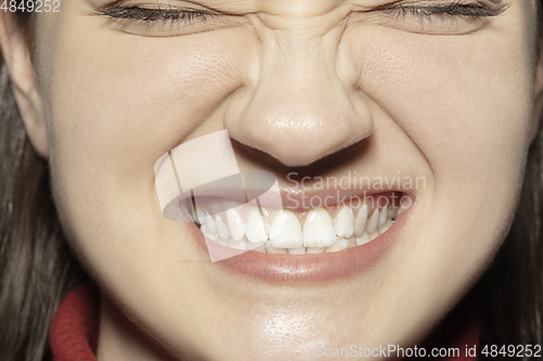 Image of Close-up female mouth with natural nude gloss lips make-up. Cosmetology, dentistry and beauty care, emotions