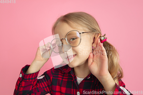 Image of Caucasian little girl\'s portrait on pink studio background