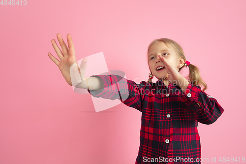 Image of Caucasian little girl\'s portrait on pink studio background