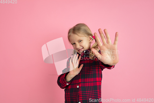 Image of Caucasian little girl\'s portrait on pink studio background