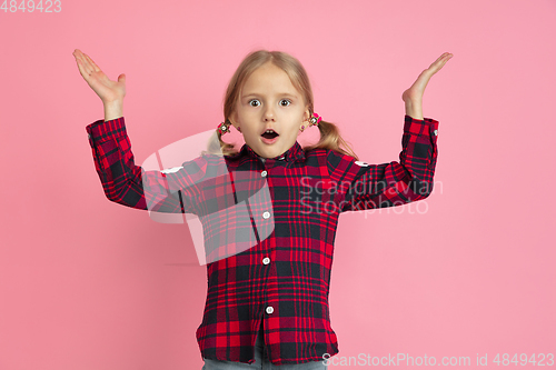 Image of Caucasian little girl\'s portrait on pink studio background
